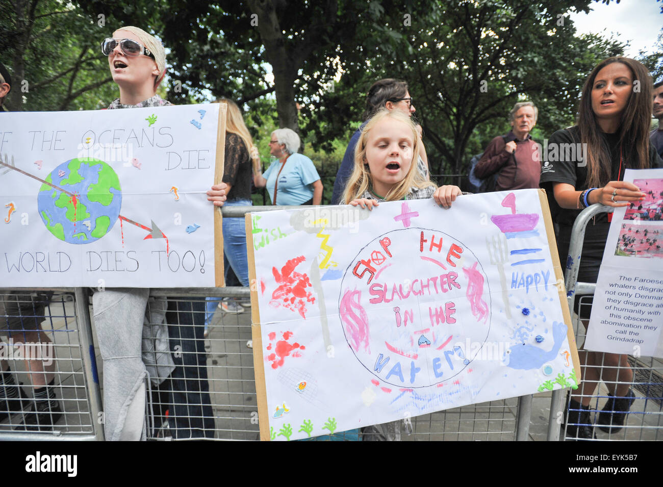 Protesters banners against killing of pilot whales and dolphins in the Faroe Islands stand outside Danish embassy London Stock Photo