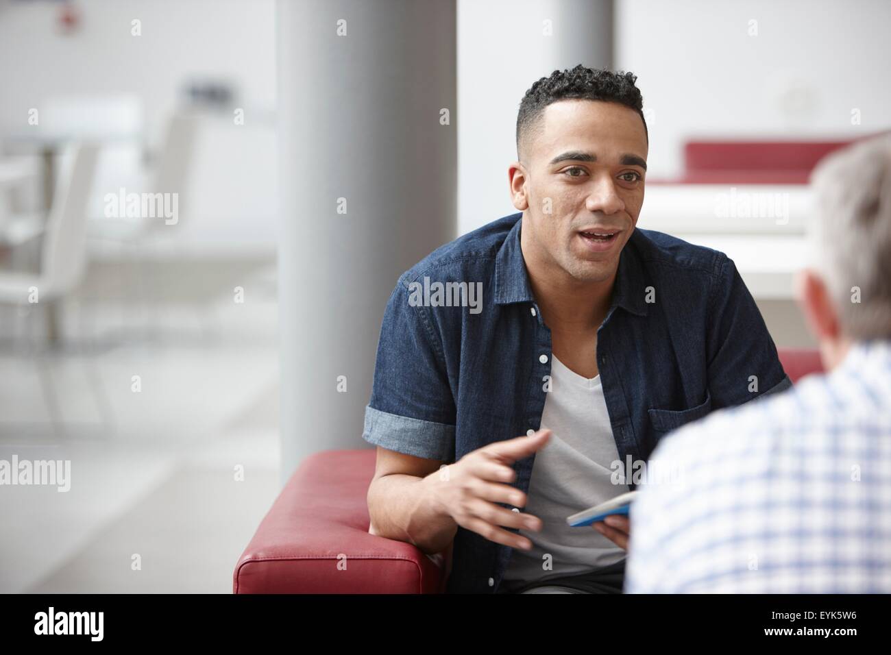 Businessmen meeting on office sofas Stock Photo