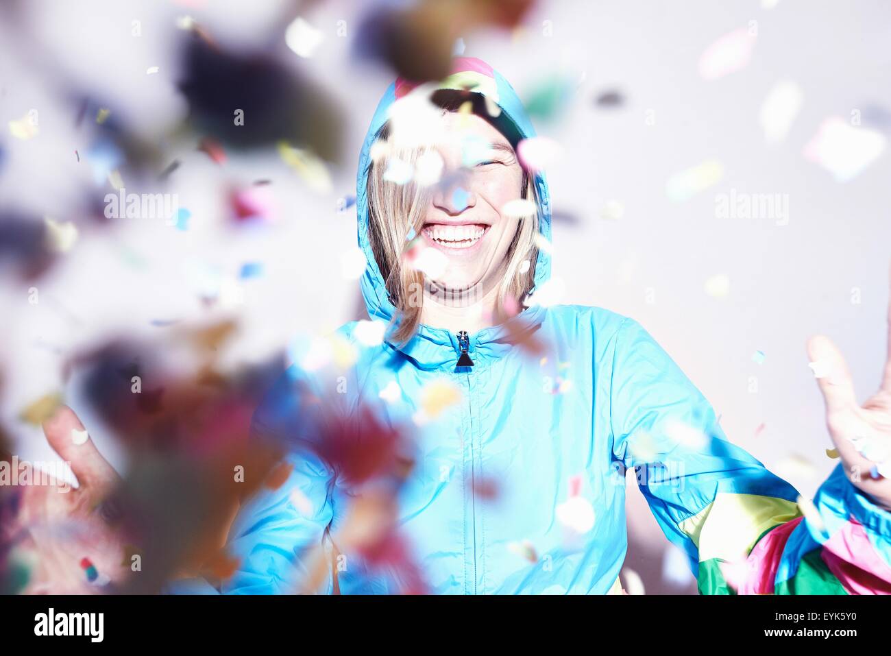 Studio shot of young woman scattering confetti Stock Photo