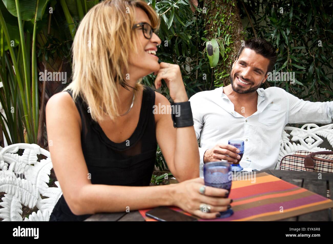 Couple enjoying drink on patio Stock Photo