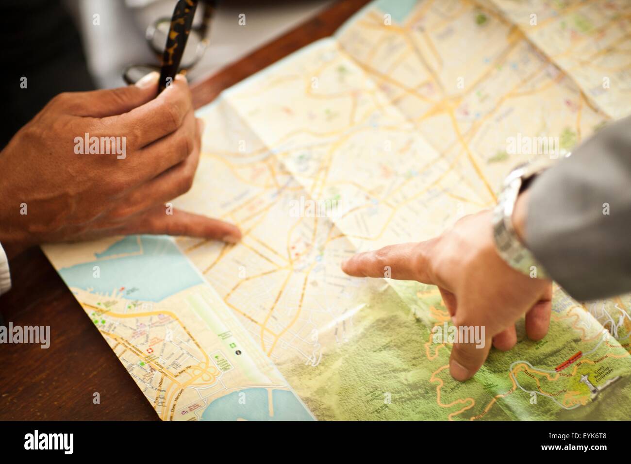 Men map-reading, view of hands Stock Photo