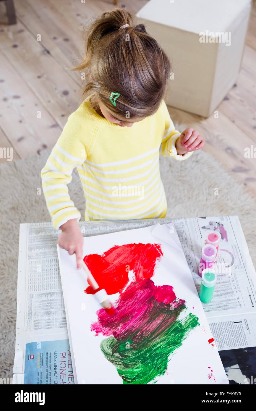 Girl painting on paper at home Stock Photo