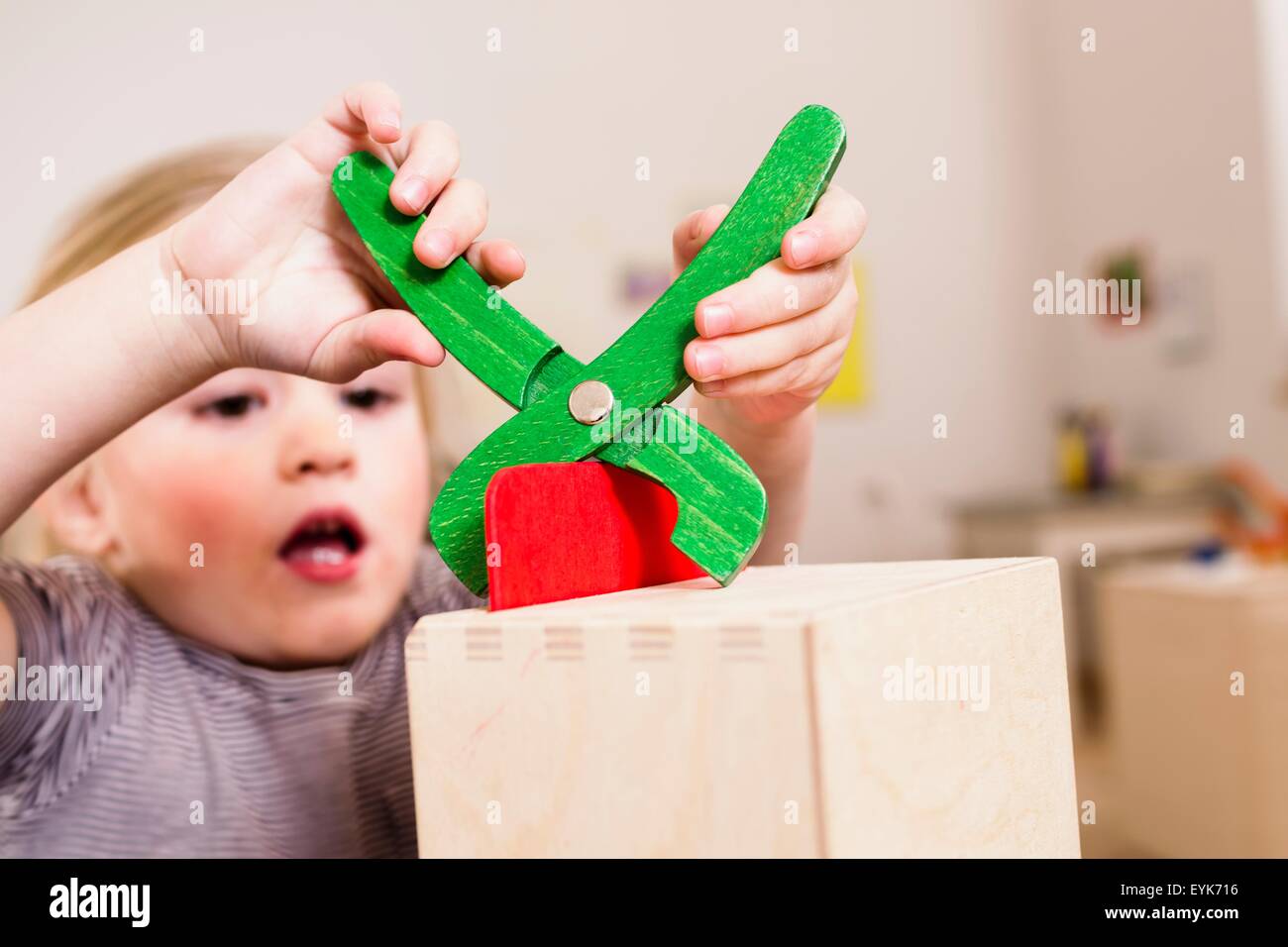 Girl playing with toy pliers Stock Photo - Alamy
