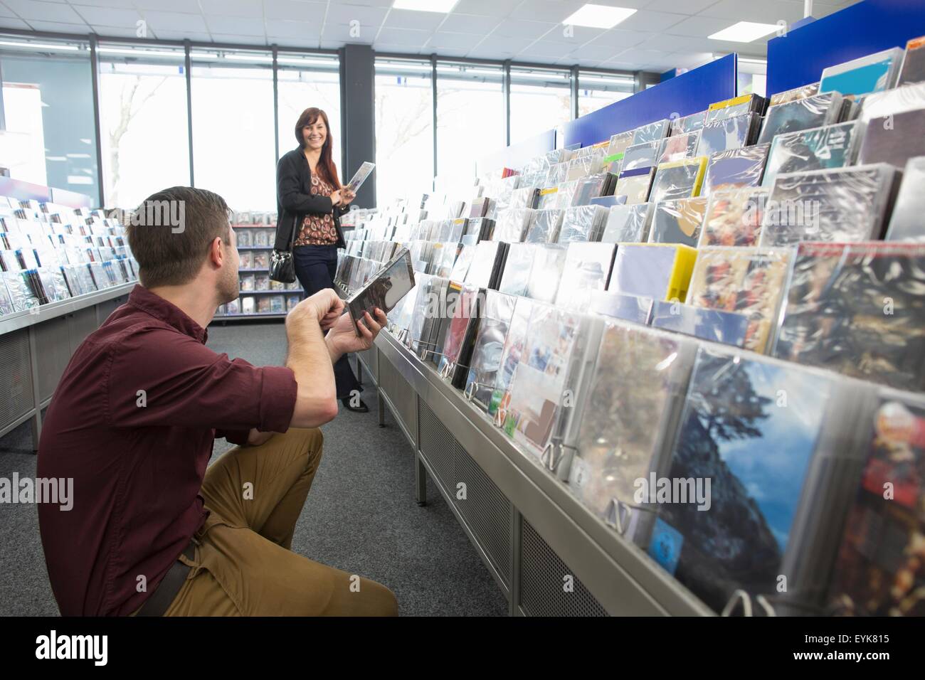 Couple shopping for DVDs in electronics store Stock Photo