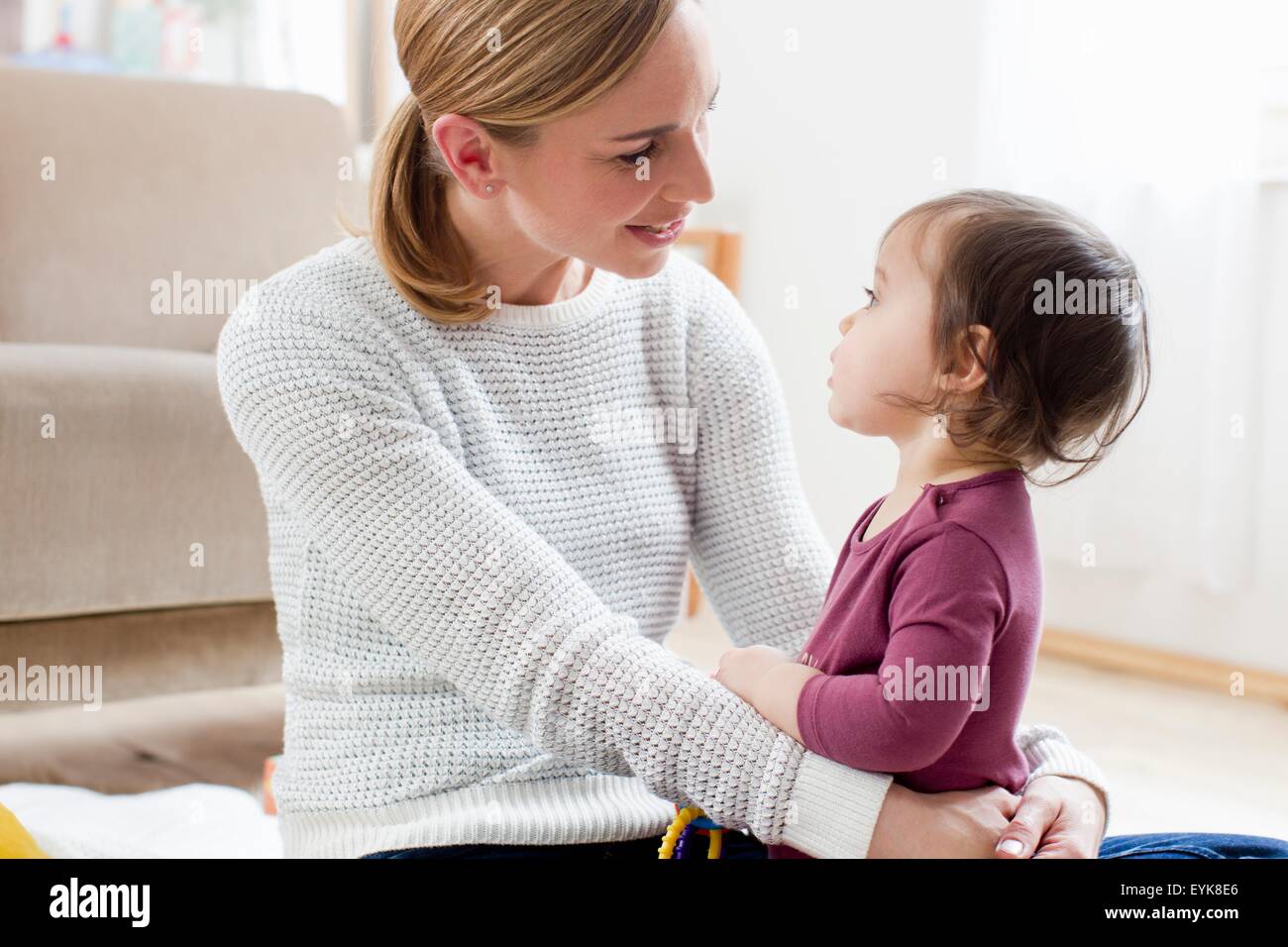 Mother and baby boy sitting face to face Stock Photo