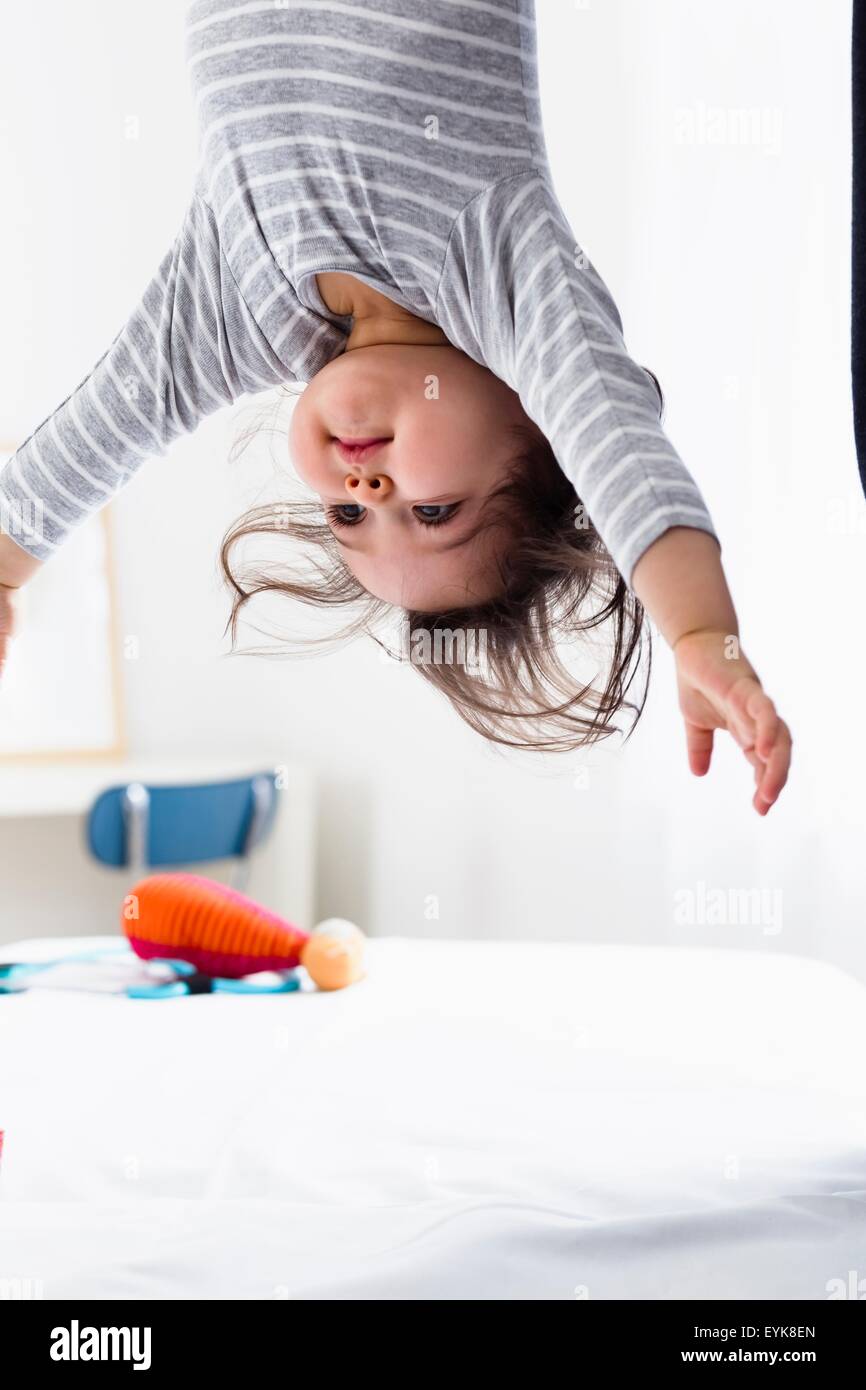 Baby boy hanging upsidedown Stock Photo Alamy