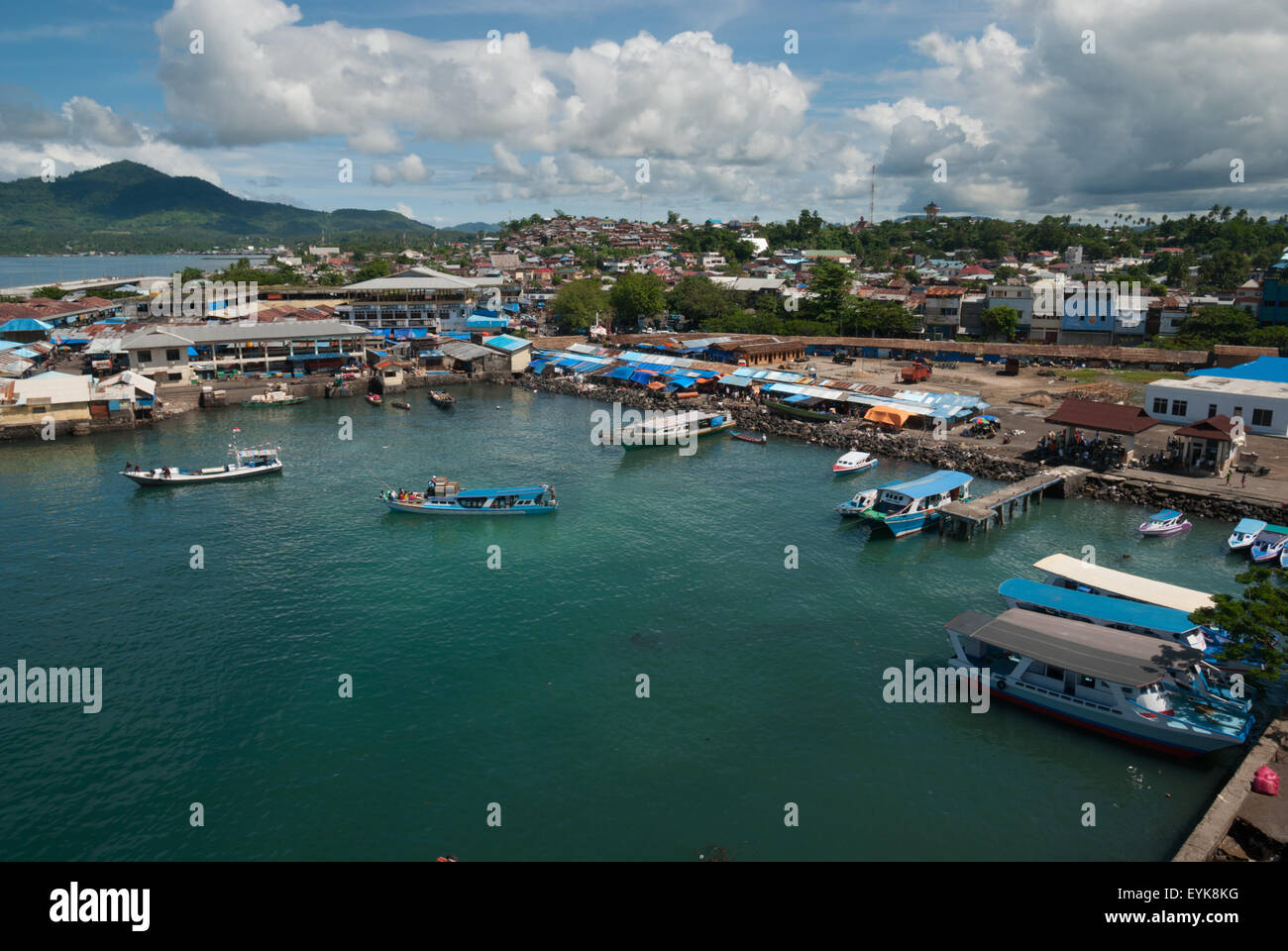 Boats, coastal water and part of the coastal landscape of Manado City in North Sulawesi, Indonesia. Stock Photo