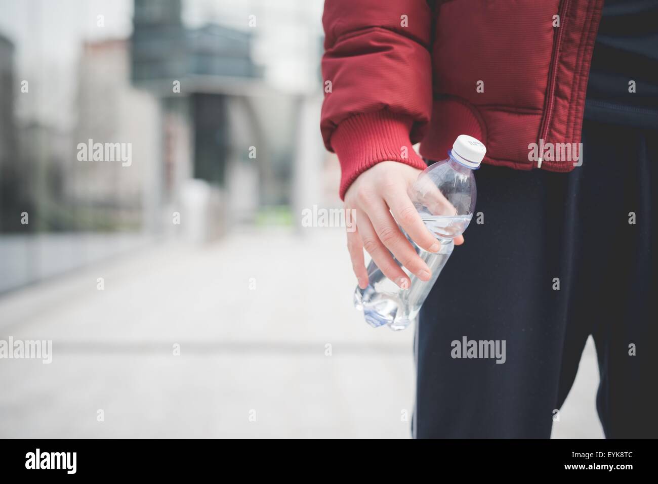 Cropped shot of young man with water bottle outside city office Stock ...