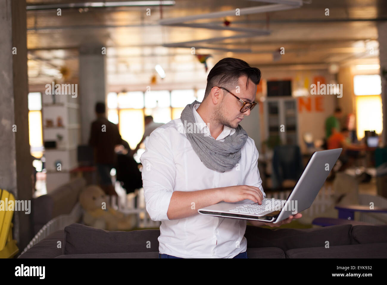 Stylish man using smartphone in startup office Stock Photo