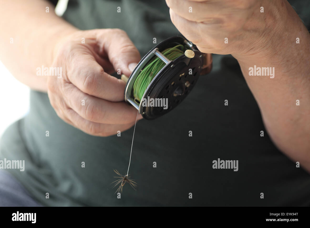 A man with a fly fishing rod and reel, artificial fly attached Stock Photo