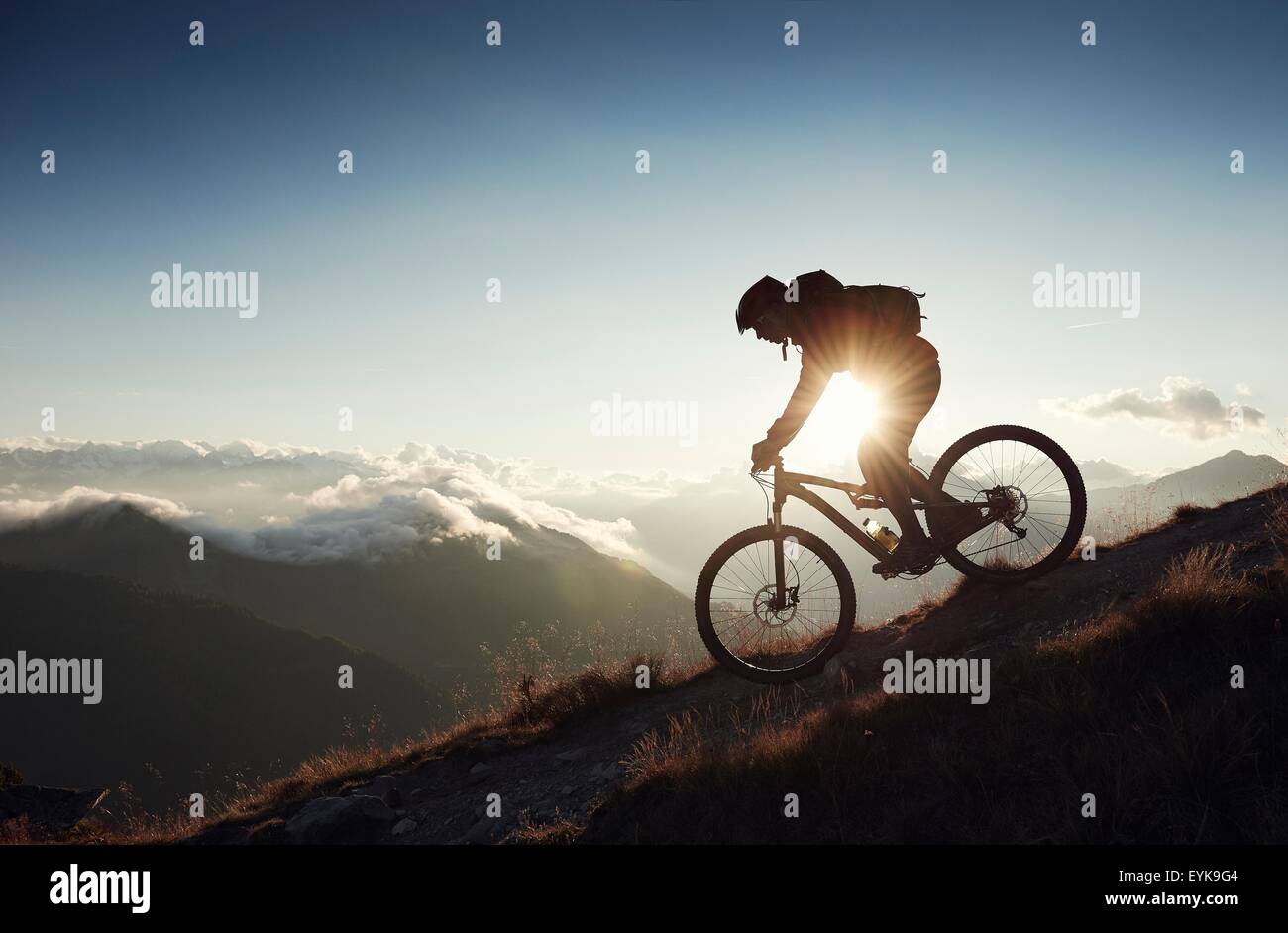 Mountain biker riding downhill, Valais, Switzerland Stock Photo