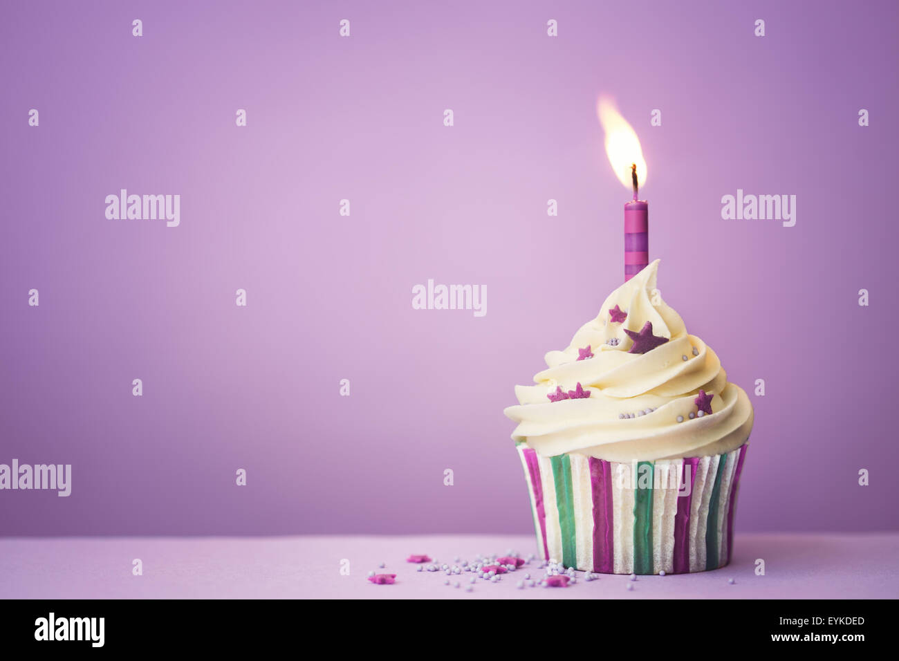 Purple birthday cupcake with copy space to side Stock Photo