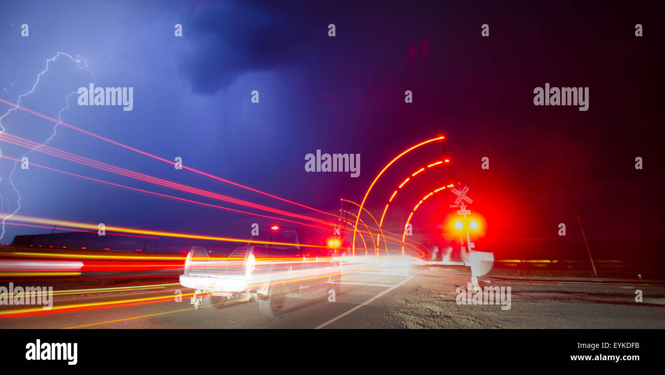 Railroad crossing at night during a thunderstorm, New Mexico, USA. Stock Photo