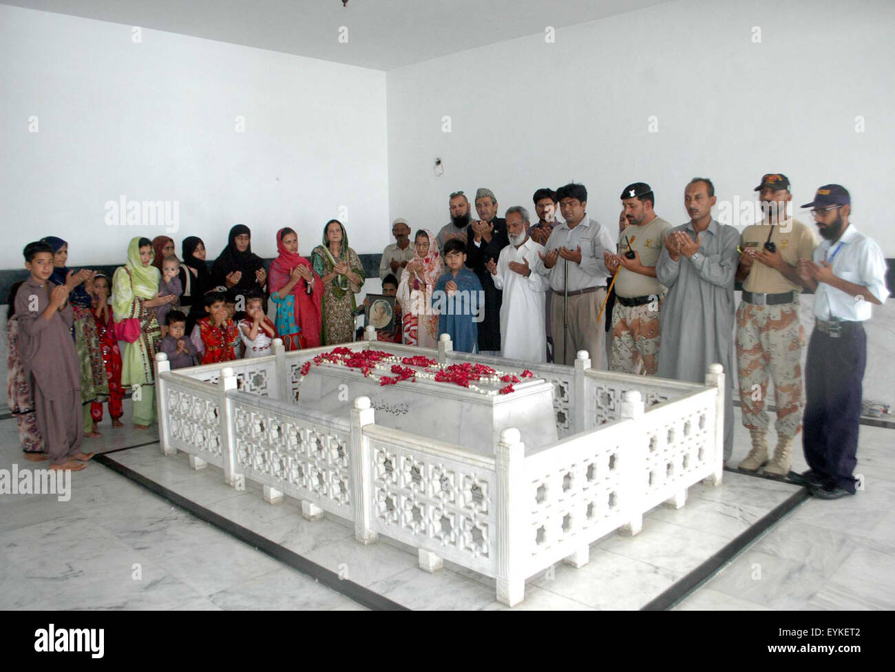 Jinnah Family members are offering prayer for departed soul of Fatima Jinnah, younger sister of Founder of Pakistan Quaid-e-Azam Muhammad Ali Jinnah on occasion of her birthday anniversary, on Fatima's grave in Karachi on Friday, July 31, 2015. Stock Photo