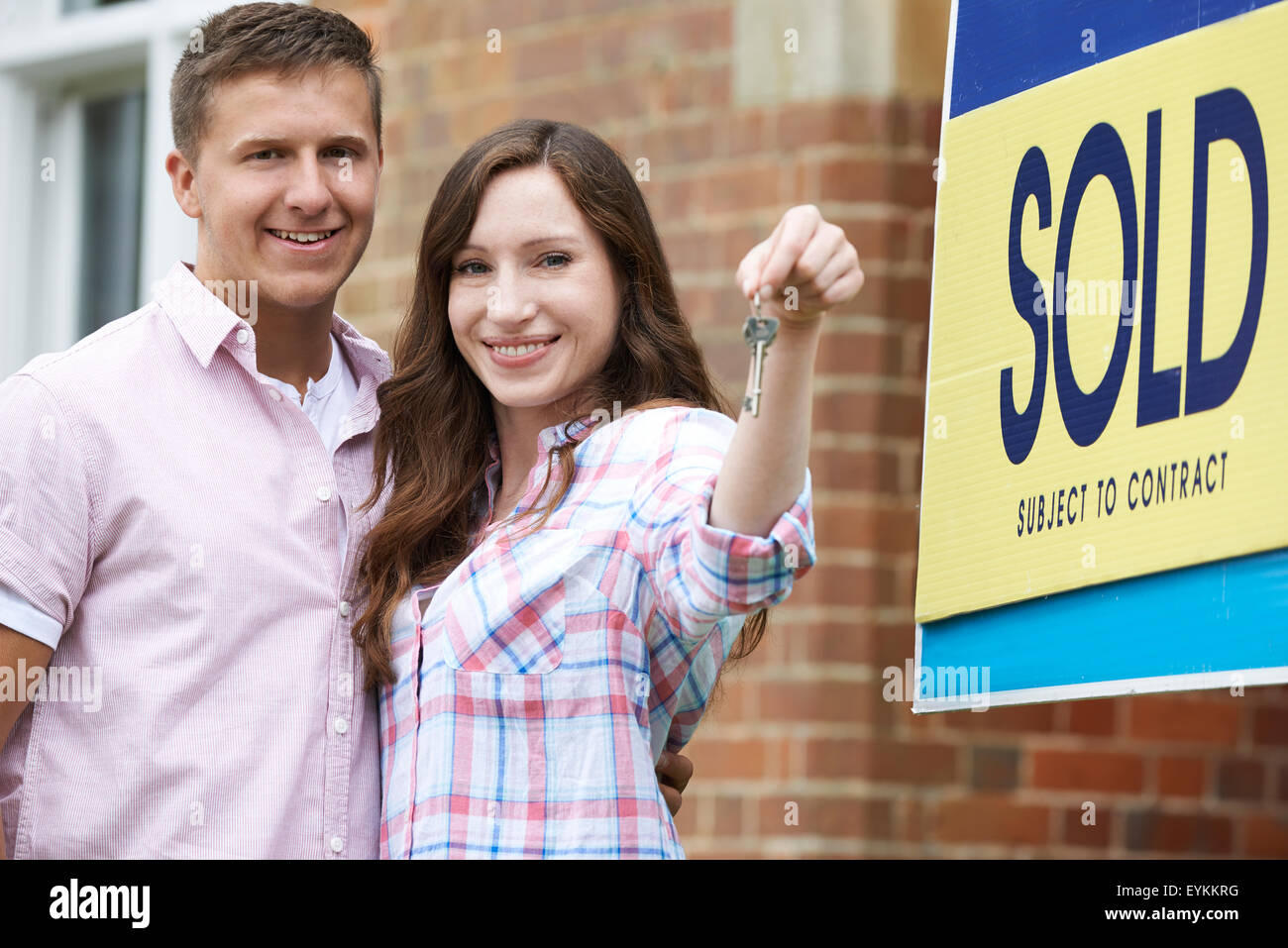 Excited Couple Outside New Home Holding Keys Stock Photo - Alamy
