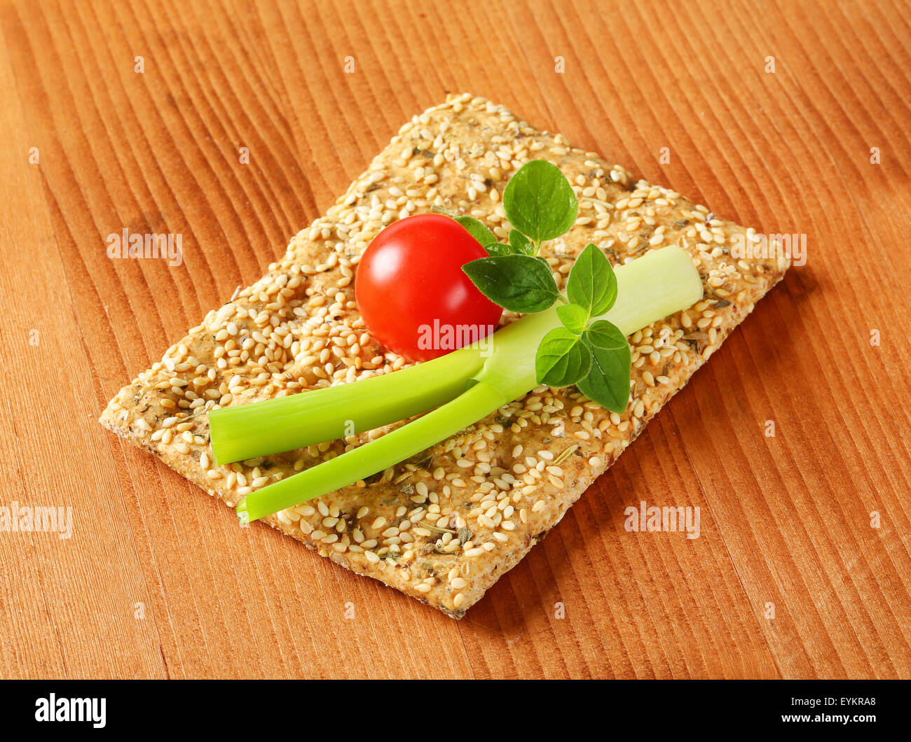Whole wheat crackers with sesame seeds and chopped herbs Stock Photo