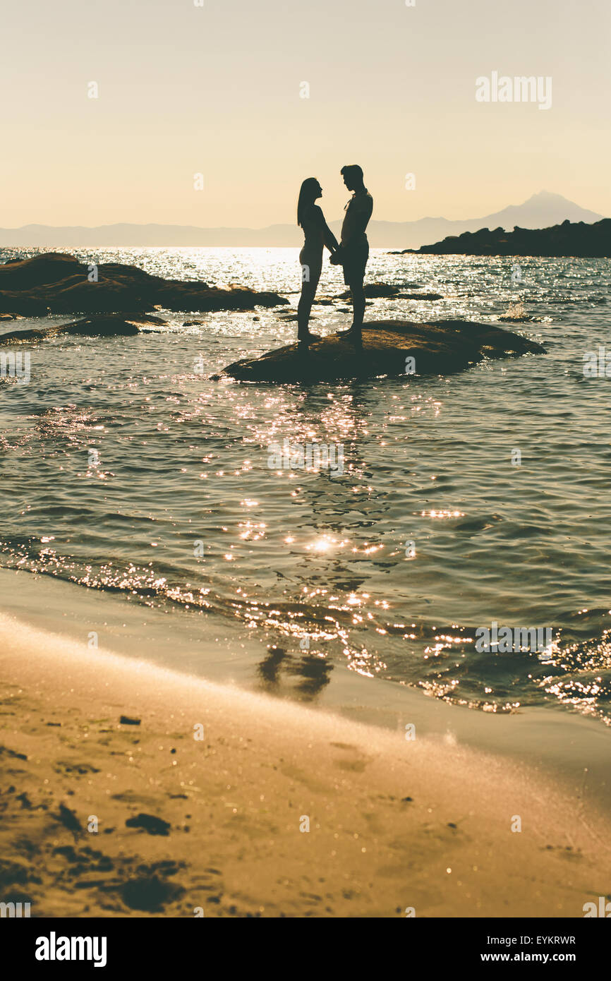 Young couple relaxing on the beach Stock Photo - Alamy