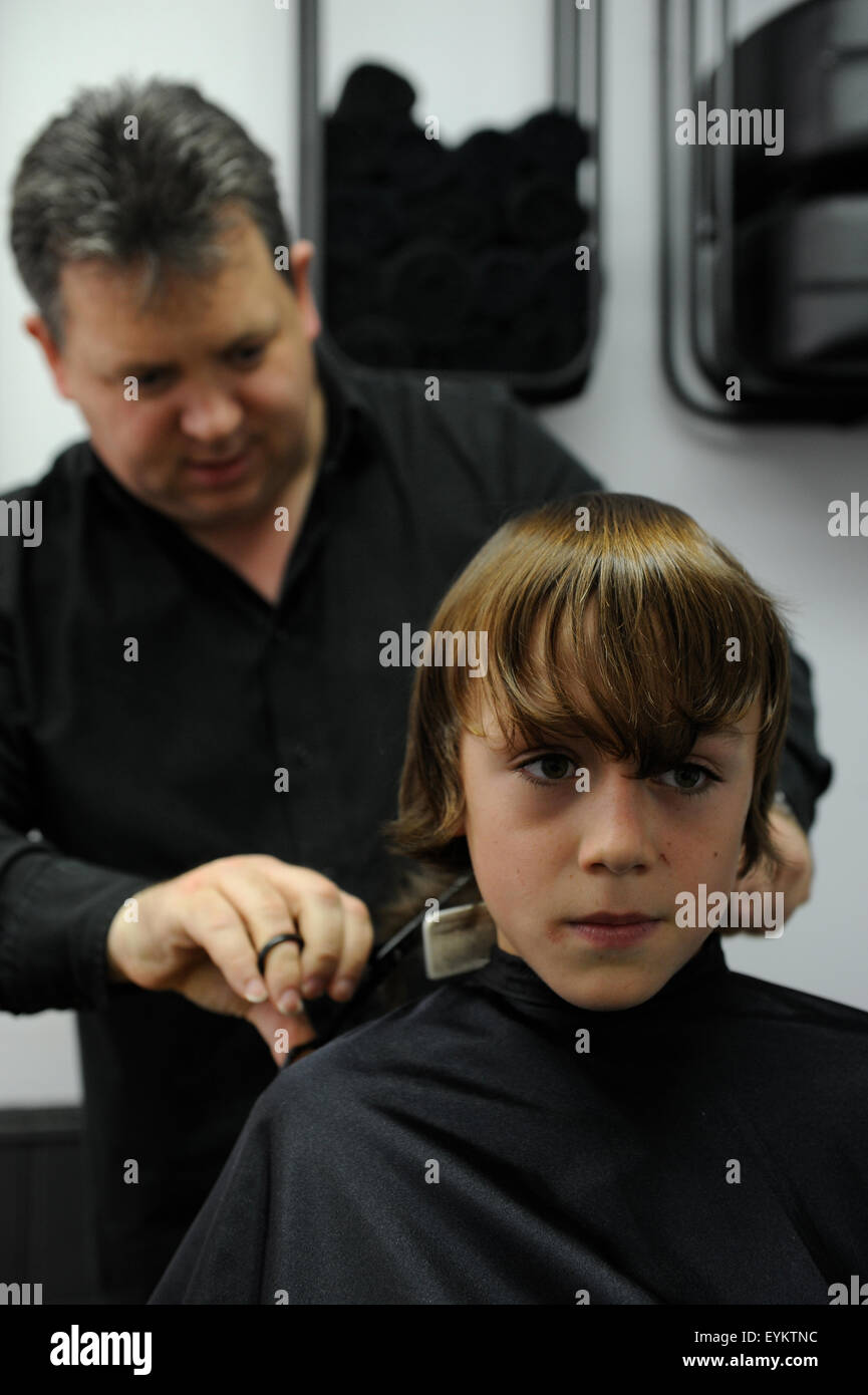 11 Year Old Caucasian Boy Having A Haircut In A Barbers Shop In