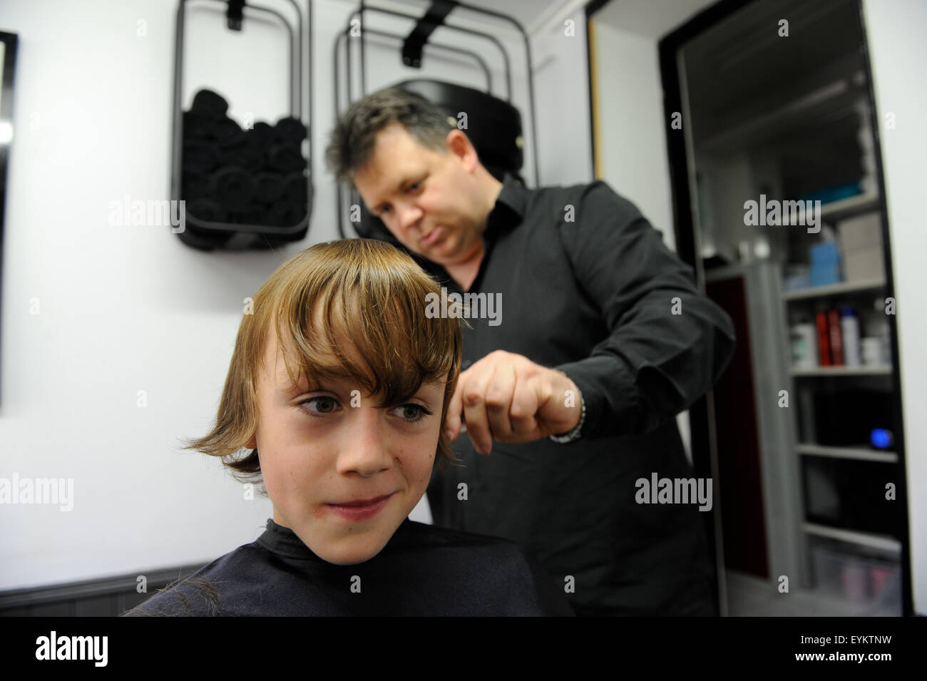 11 Year Old Caucasian Boy Having A Haircut In A Barbers Shop In