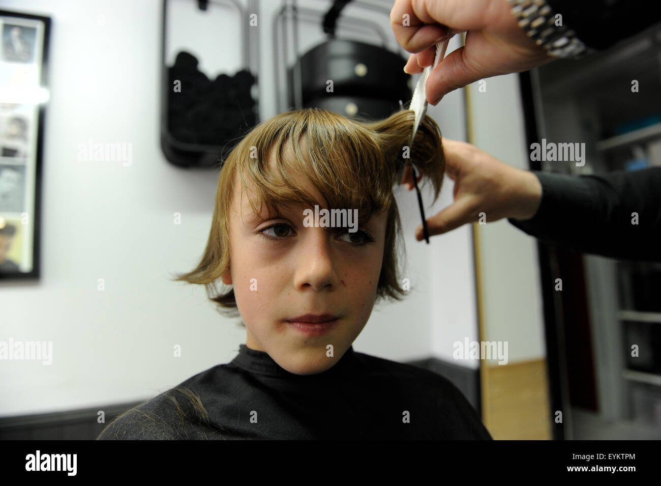 11 Year Old Caucasian Boy Having A Haircut In A Barbers Shop In