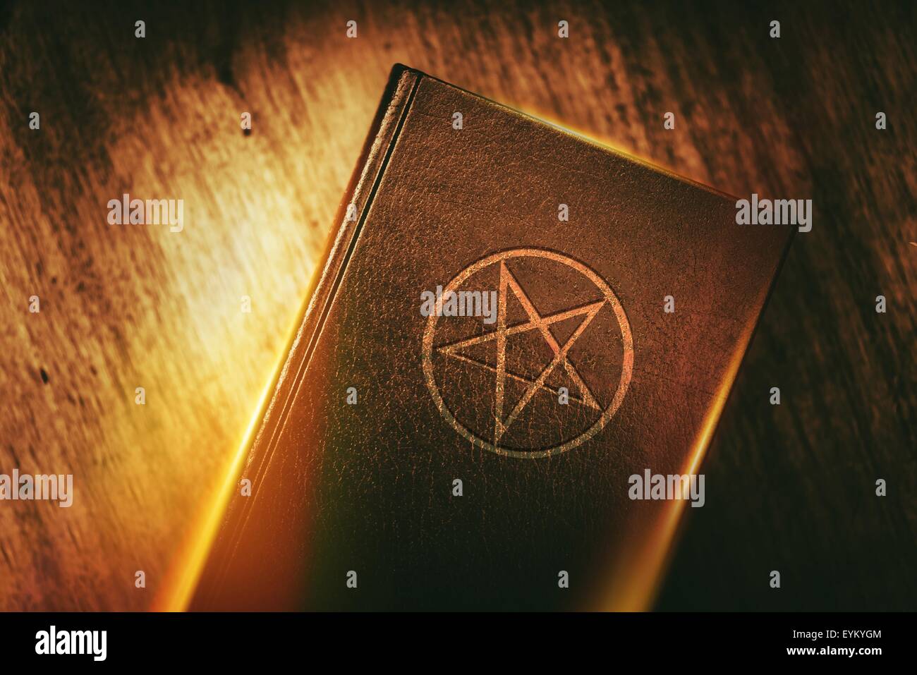 Old Mysterious Book with Pentagram Sign on the Cover. Stock Photo