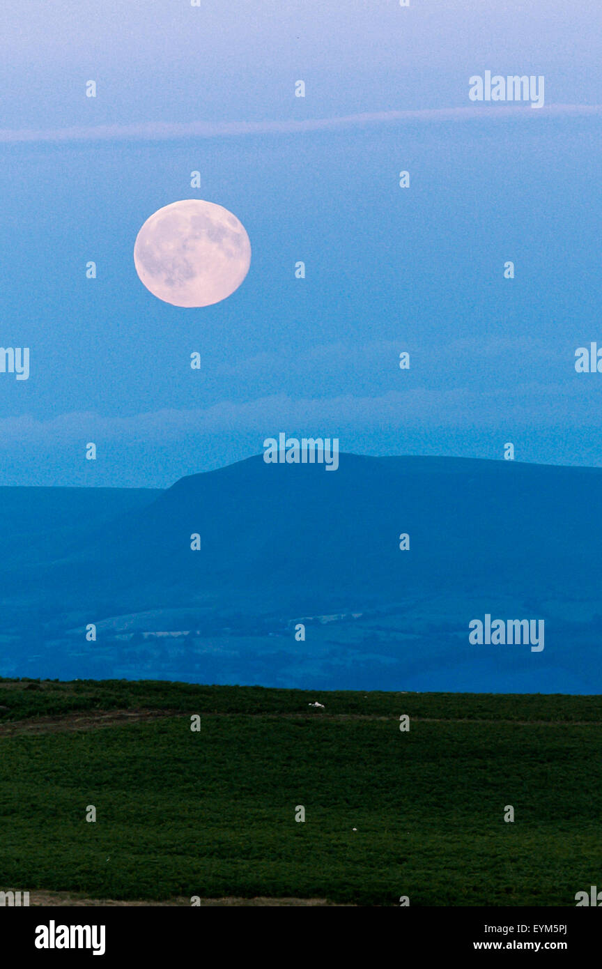Mynydd Epynt, Powys, UK. 23rd July 2015. A ‘Blue Moon’ rises above the Mynydd Epynt high moorland in Mid Wales. Credit:  Graham M. Lawrence/Alamy Live News. Stock Photo