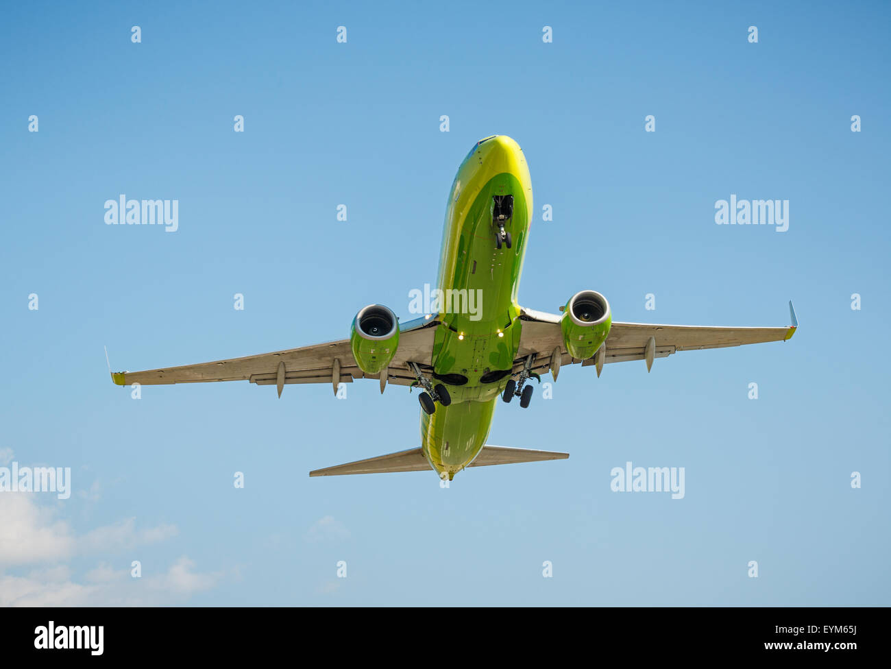 Airplane in the blue sky Stock Photo - Alamy