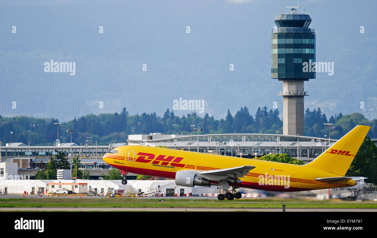 Atlas Air Boeing 767 (N653GT) package freighter painted in DHL livery take taking off airborne Vancouver International Airport Stock Photo