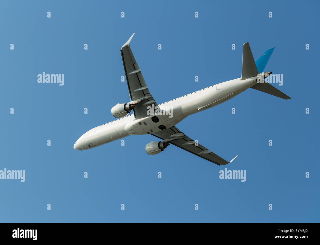 Airplane in the blue sky Stock Photo - Alamy