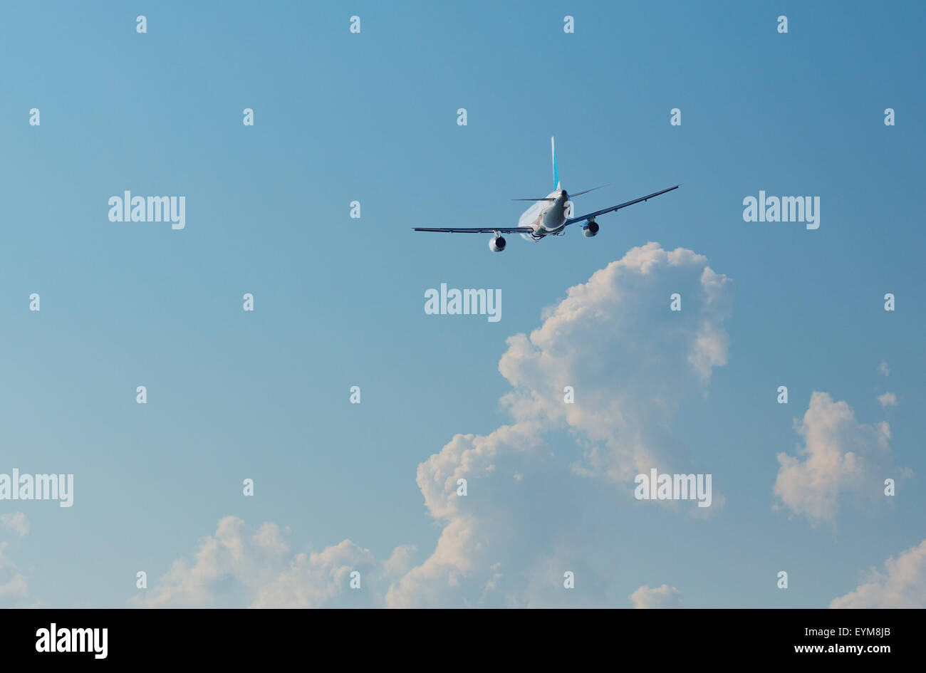 Airplane in the blue sky Stock Photo - Alamy