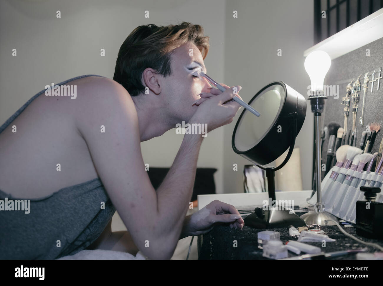 Male drag queen putting on make up and dressing up in preparation for a performance show Stock Photo