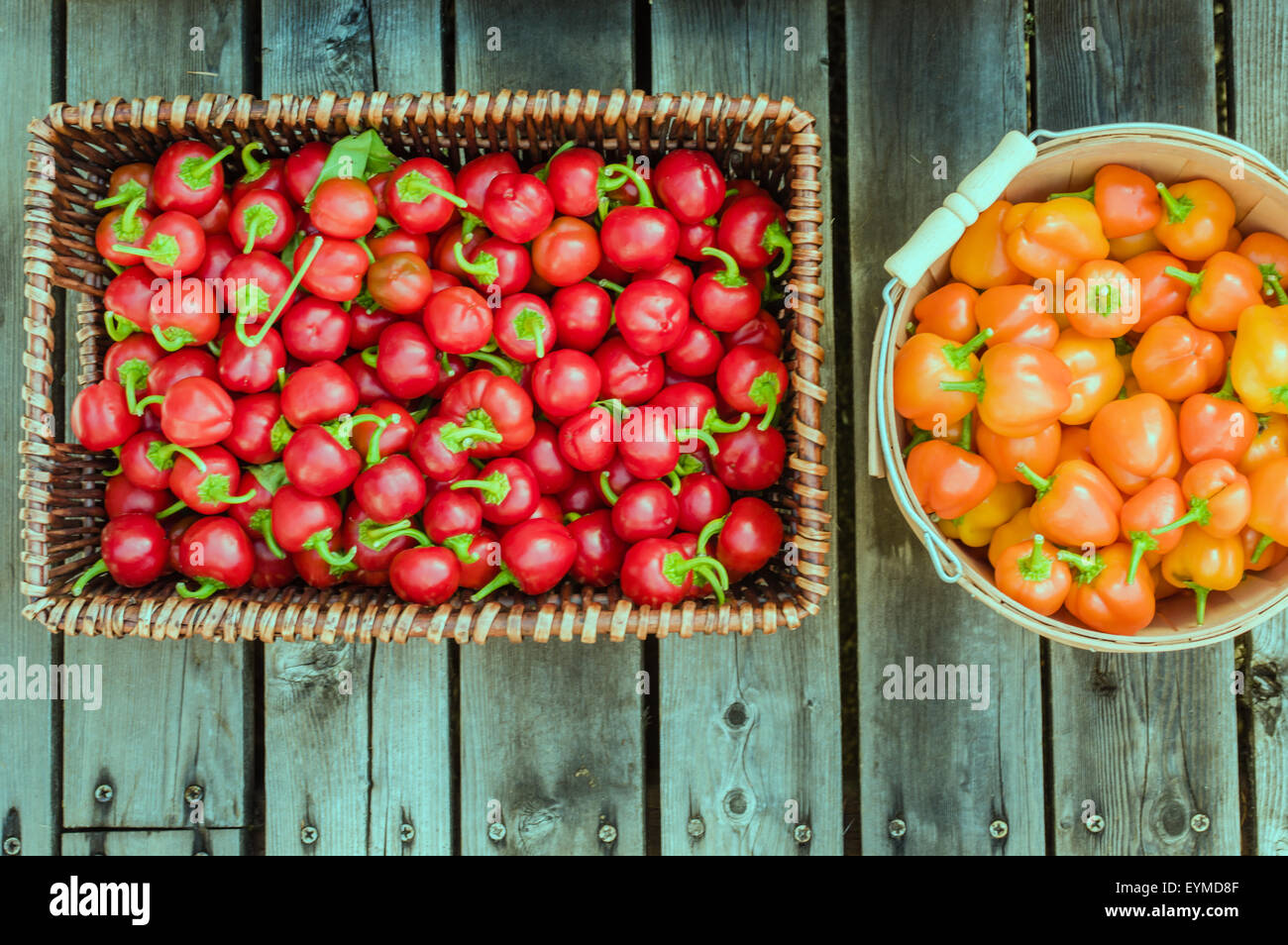 Red and orange hot peppers in wooden baskets Stock Photo - Alamy