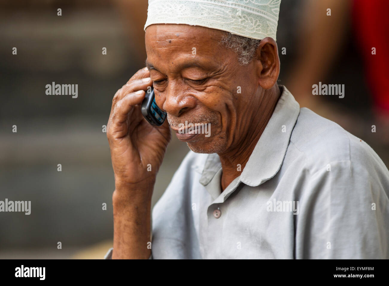 Tanzania, Zanzibar, Zanzibar City, historical centre Stone Town, old man with mobile phone Stock Photo