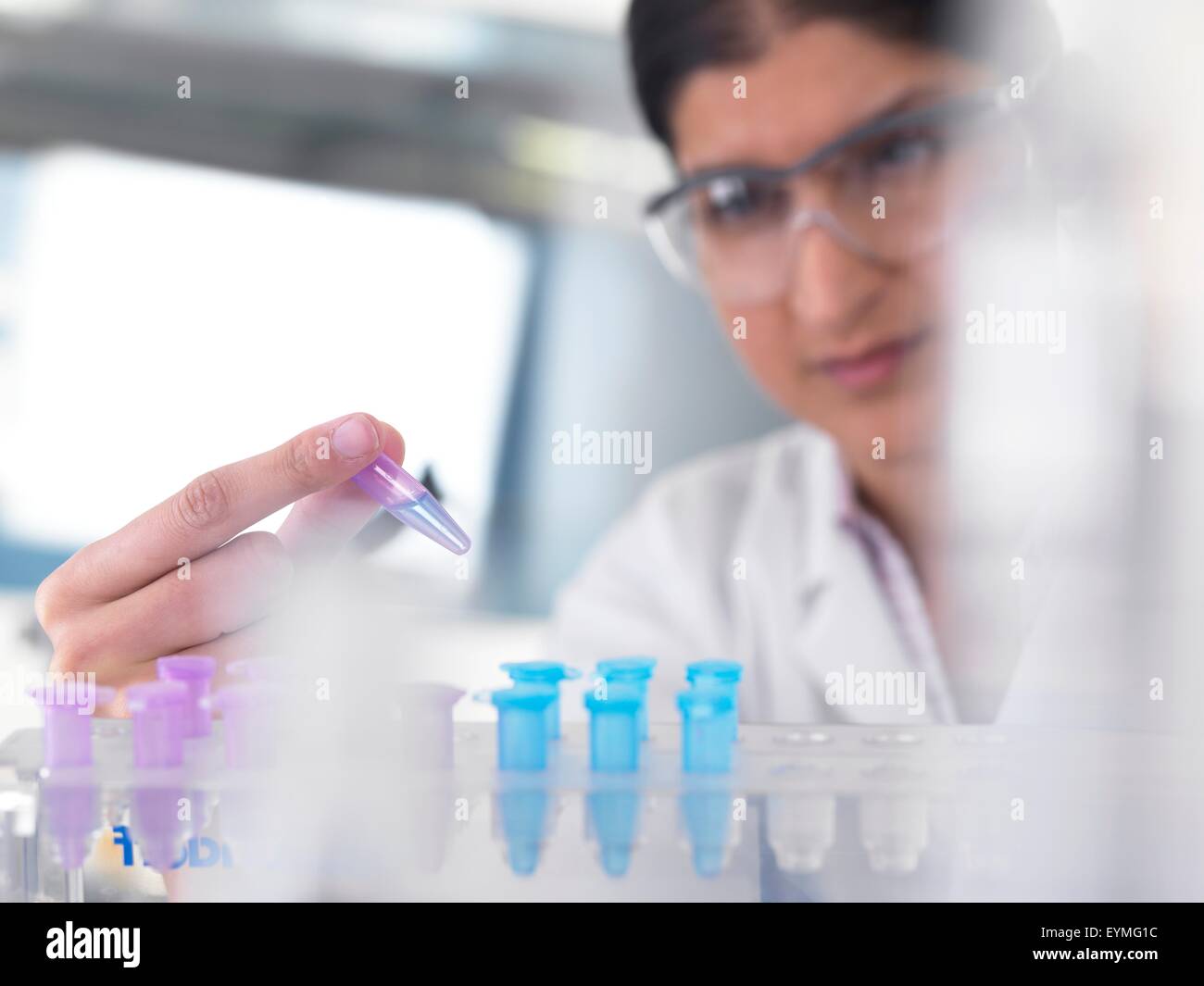PROPERTY RELEASED. MODEL RELEASED. Female Asian scientist holding a sample ready for analytical testing. Stock Photo