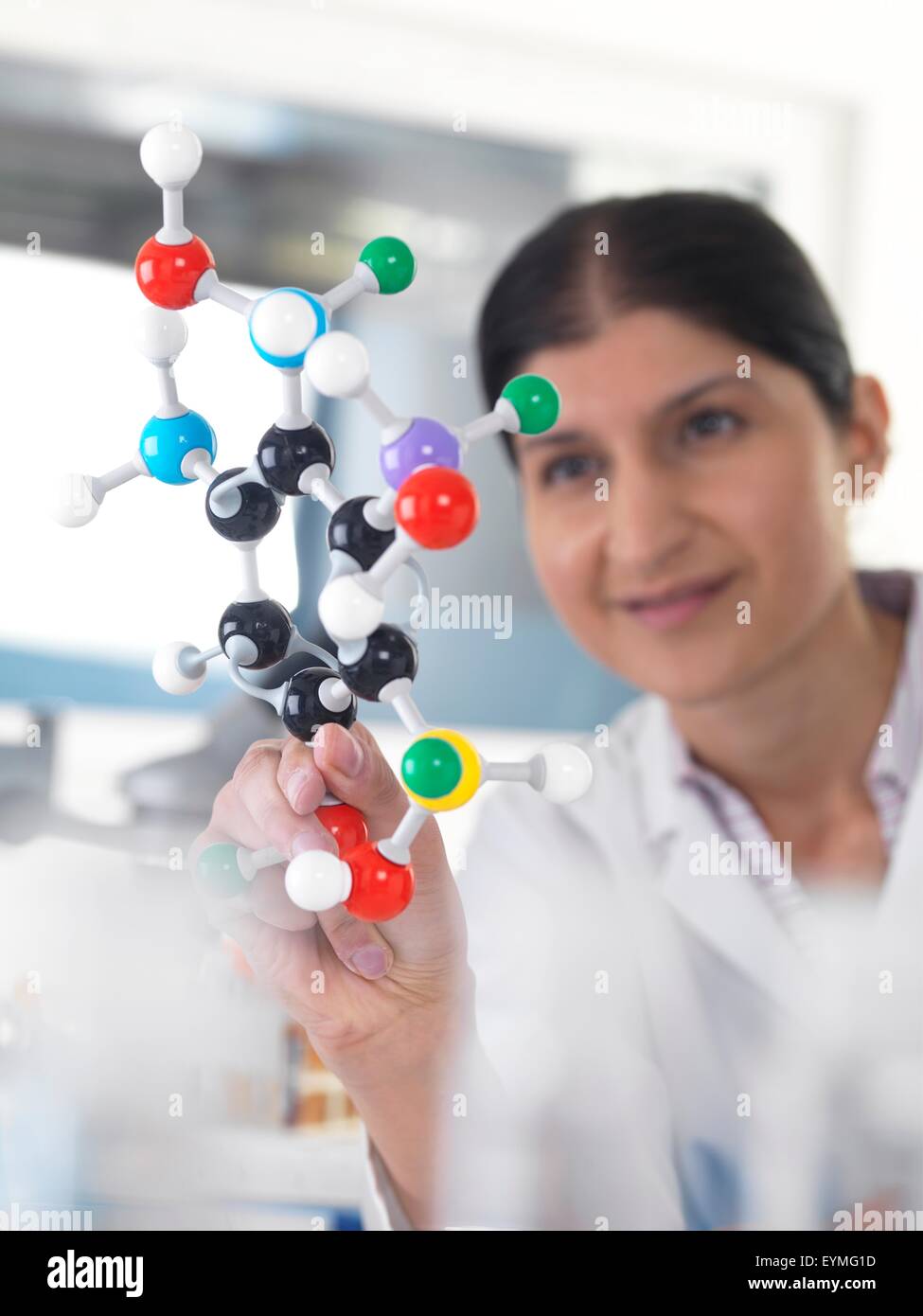 PROPERTY RELEASED. MODEL RELEASED. Female Asian using a molecular model
