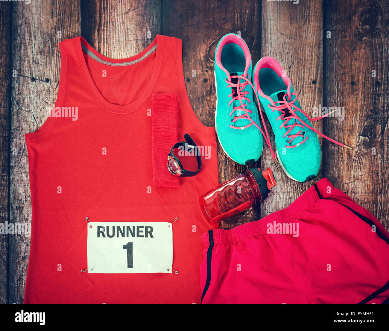 Running gear laid out ready for a race day, rustic wooden background Stock Photo