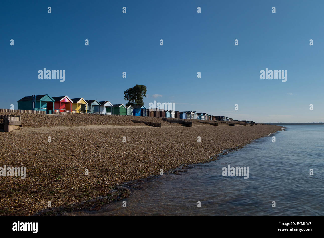 Calshot Beach and Beach Huts at Calshot in Hampshire UK Stock Photo
