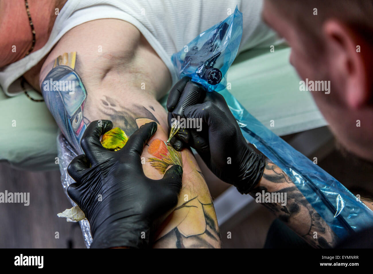 Premium Photo  Master posing in tattoo parlourprofessional tattooist  works in studio