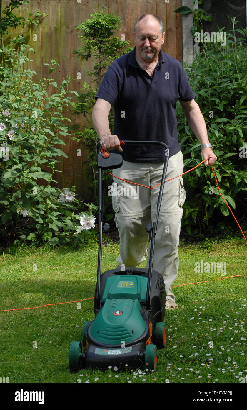 man mowing lawn Stock Photo