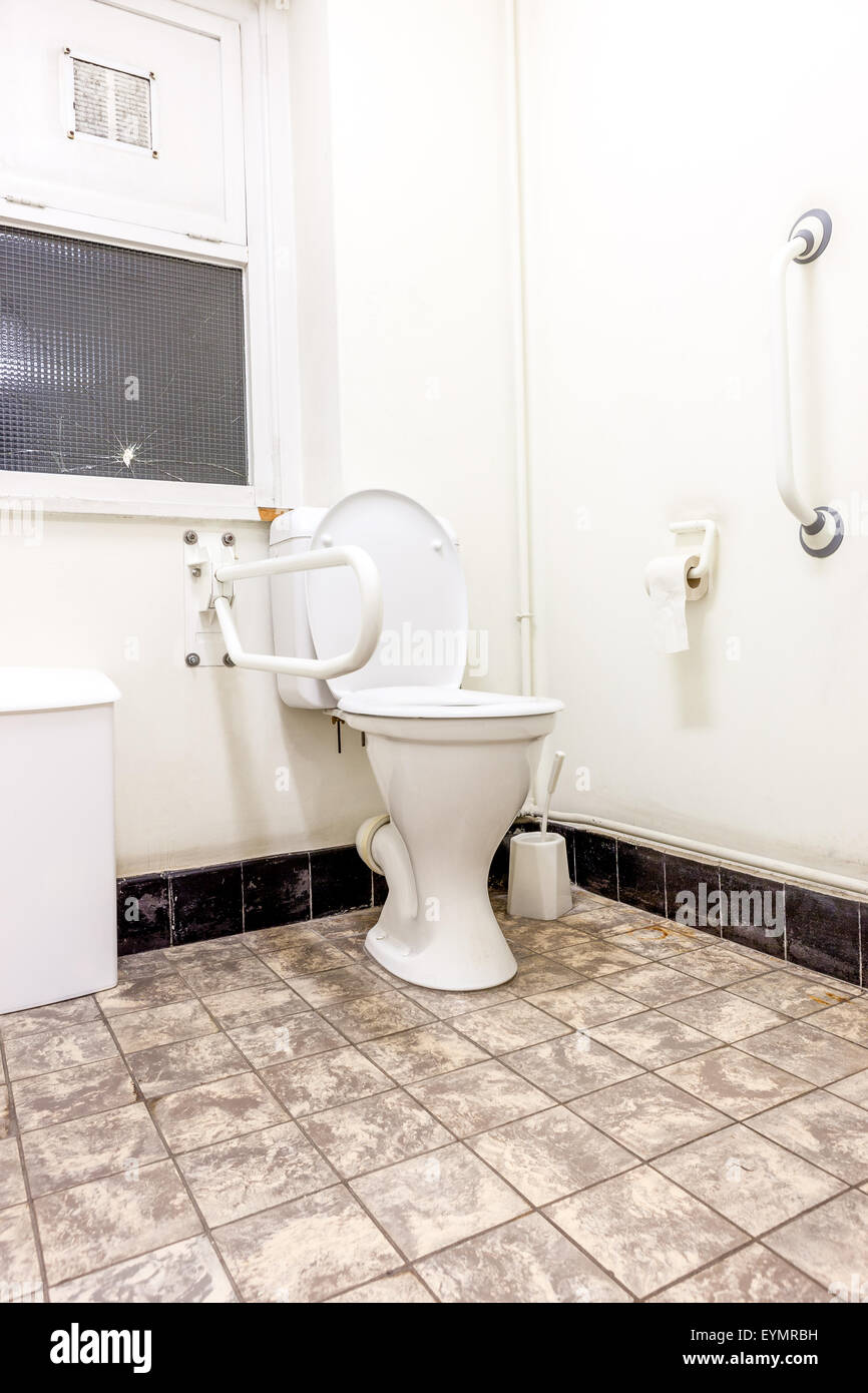 disabled toilet with a broken glass panes Stock Photo