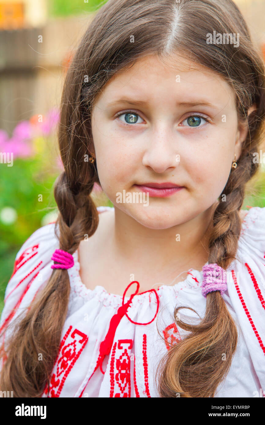 Portrait of a 10 year old girl wearing a Romanian traditional blouse. Stock Photo