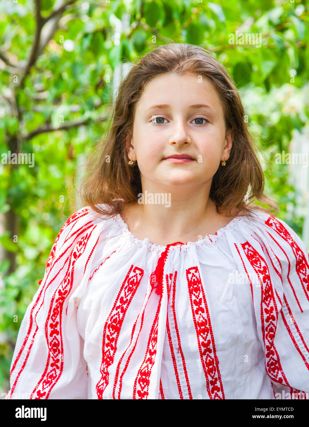 Portrait of a 10 year old girl wearing a Romanian traditional blouse. Stock Photo