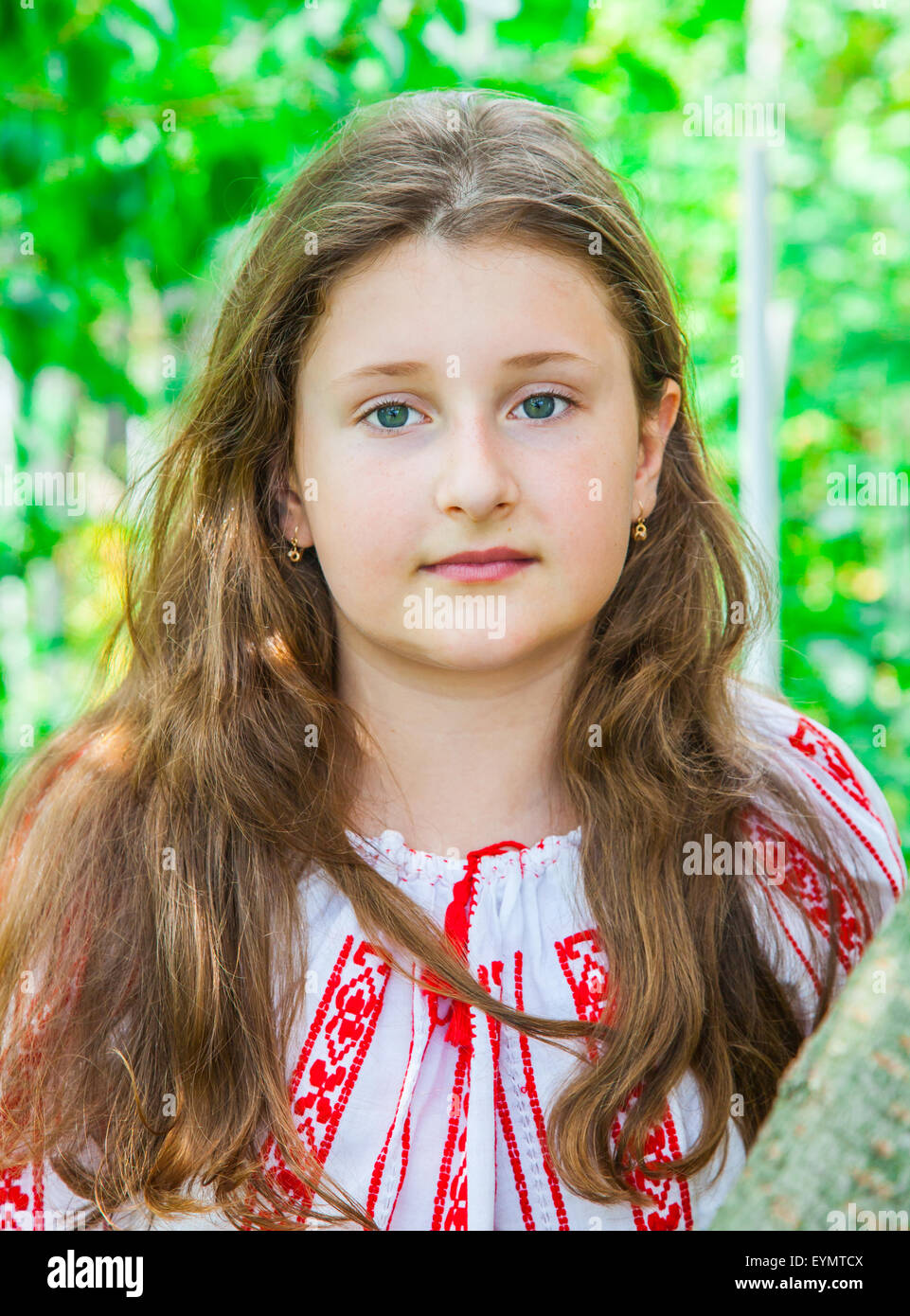 Portrait of a 10 year old girl wearing a Romanian traditional blouse. Stock Photo