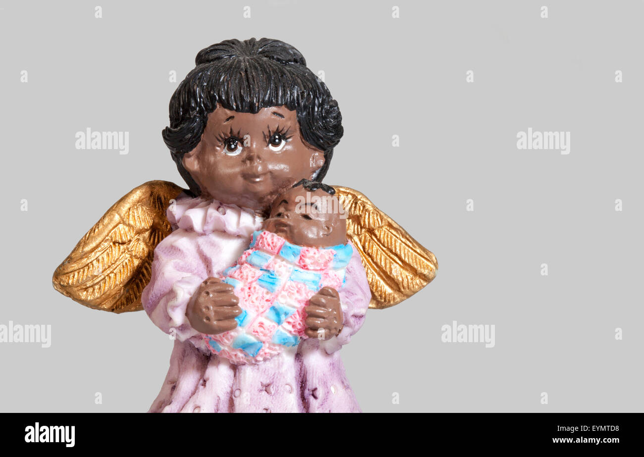 dark-skinned Christmas angel with a baby, Stock Photo