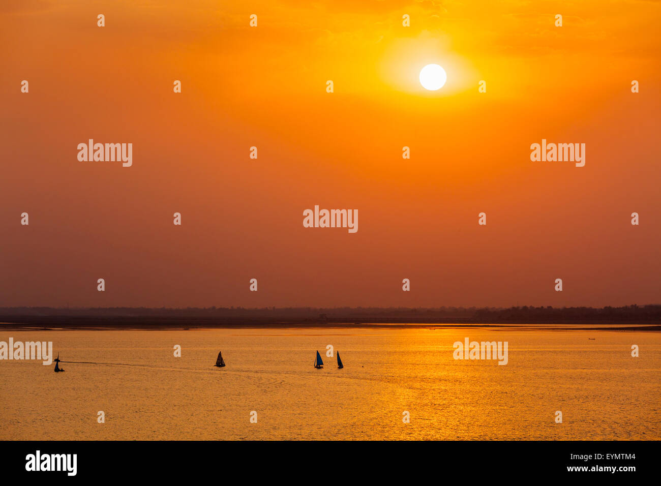 Yacht boats silhouettes in lake on sunset Stock Photo - Alamy