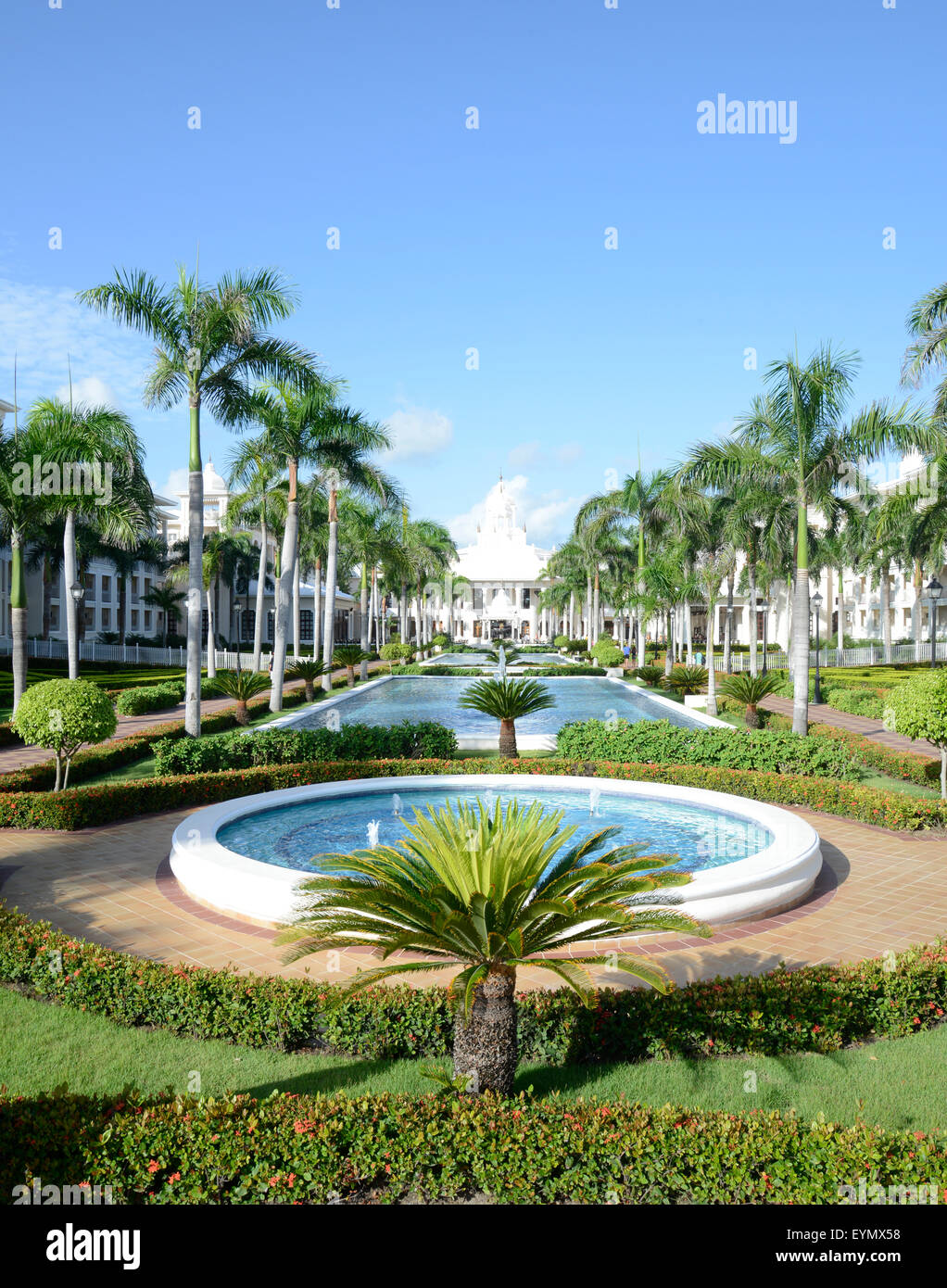water fountain at a tropical resort. The fountain is surrounded by lush ...