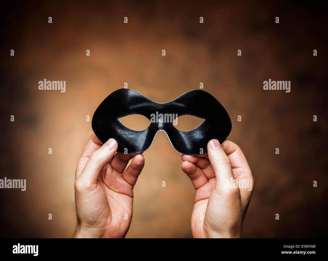 Man holding a black eye mask in his hands Stock Photo Alamy