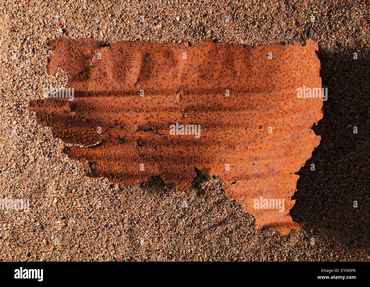 Rusty piece of a metallic barrel. Stock Photo