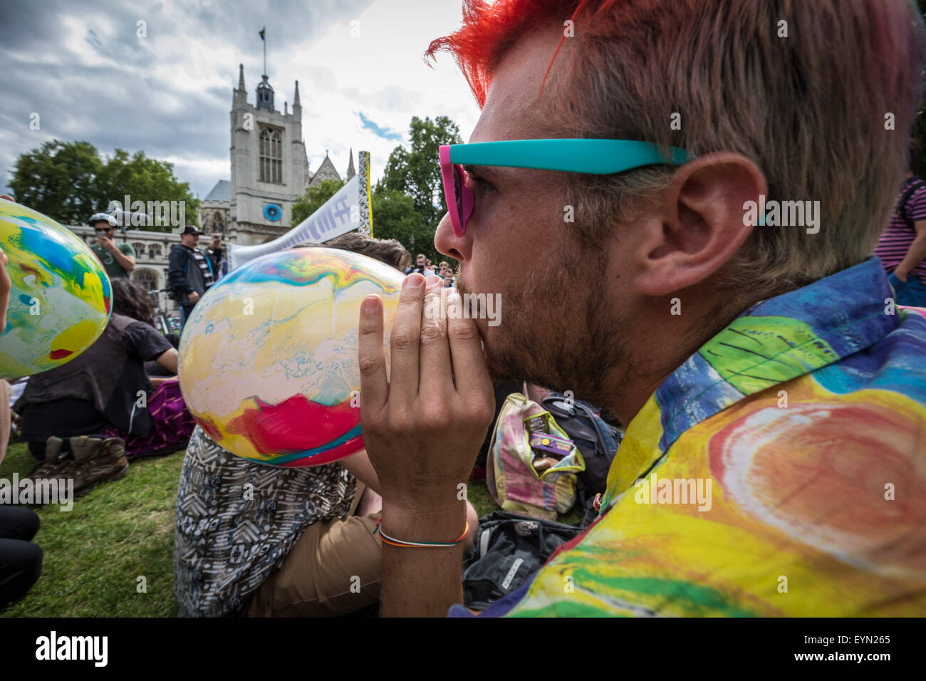London, UK. 1st August, 2015. Campaigners inhale balloons inflated with nitrous oxide, commonly known as “laughing gas” to get high during a protest in Westminster’s Parliament Square against a proposed bill that aims to make selling any psychoactive substance illegal. Credit: Guy Corbishley/Alamy Live News Stock Photo