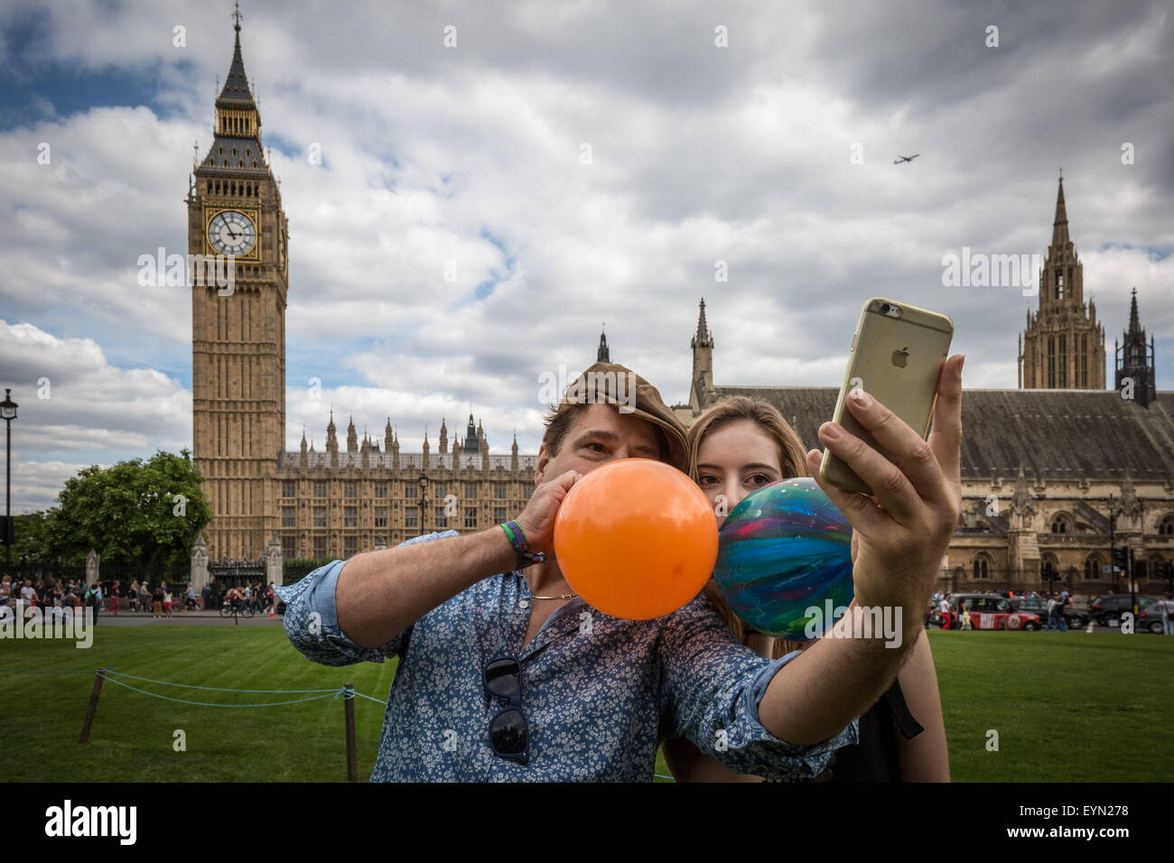 London, UK. 1st August, 2015. Campaigners inhale balloons inflated with nitrous oxide, commonly known as “laughing gas” to get high during a protest in Westminster’s Parliament Square against a proposed bill that aims to make selling any psychoactive substance illegal. Credit: Guy Corbishley/Alamy Live News Stock Photo